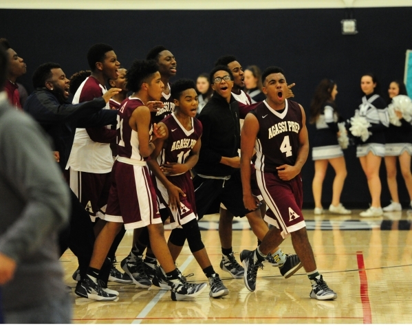 Agassi Prep forward Daniel Plummer (4) and teammates celebrate their 60-59 victory over The ...
