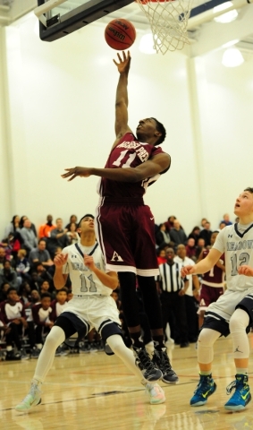 Agassi Prep forward Jared Holmes goes up for a shot against The Meadows in the third quarter ...