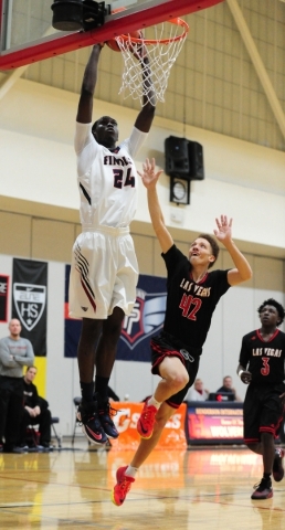 Findlay Prep guard Lamine Diane (24) dunks against Las Vegas guard Jason Cullen (42) in the ...