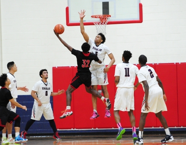Las Vegas guard Dartanion Myers goes up for a shot against Findlay Prep guard P.J. Washingto ...