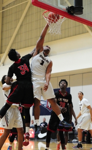 Findlay Prep guard Carlos Johnson (3) dunks against Las Vegas wing Marquise Raybon (34) in t ...