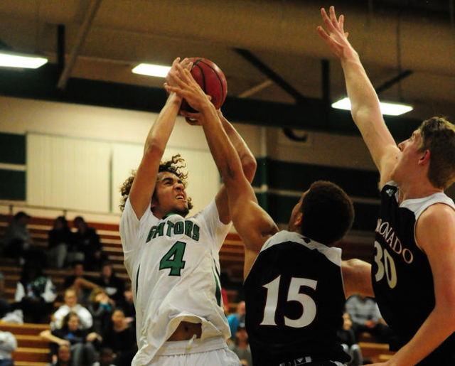 Green Valley guard Xavier Jarvis (4) goes up for a shot against Coronado forward Kennedy Koe ...