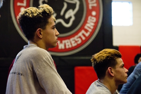 Antonio Saldate, left, listens to head coach Zach Hocker during practice inside the wrestlin ...