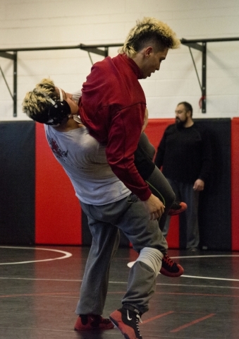 Antonio Saldate, left, spars with Nick Sablan during practice inside the wrestling room at L ...