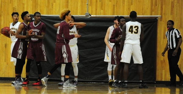Bonanza forward John Holden (behind #43) and teammates react after Holden was called for a f ...