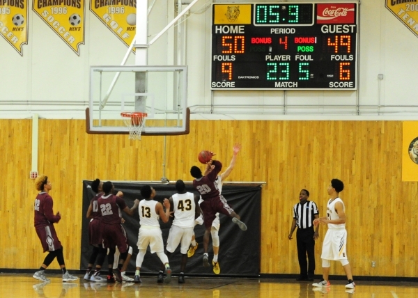 Bonanza forward John Holden fouls Cimarron-Memorial guard Ja‘Don Brown (20) as time ex ...