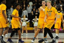 Clark Chargers celebrate their 63-45 victory over Faith Lutheran during their prep basketba ...