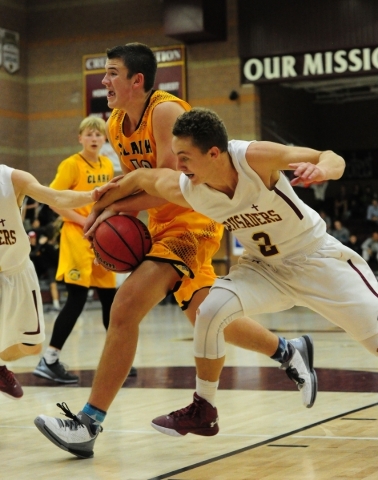 Faith Lutheran guard Blake Bell (2) fouls Clark Chargers guard James Bridges (15) in the fou ...