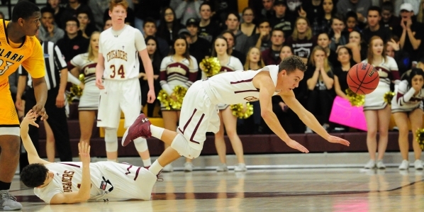 Faith Lutheran guard Blake Bell, right, trips over teammate Luke Bergen in the second quarte ...