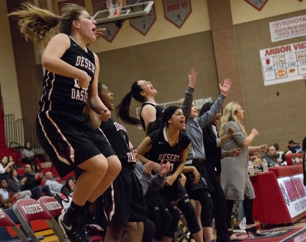 Players and coaches on the Desert Oasis bench celebrate during their game against Arbor View ...