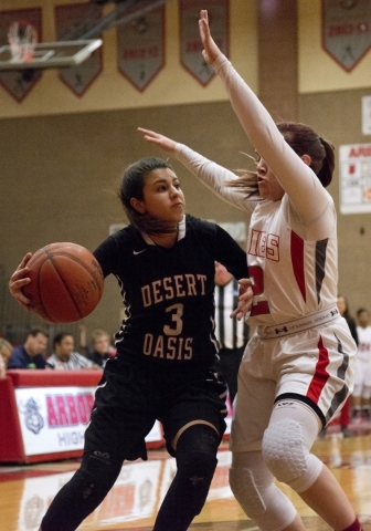 Desert Oasis guard Mikala Kirby (3) works the ball toward the basket as Arbor View‘s K ...