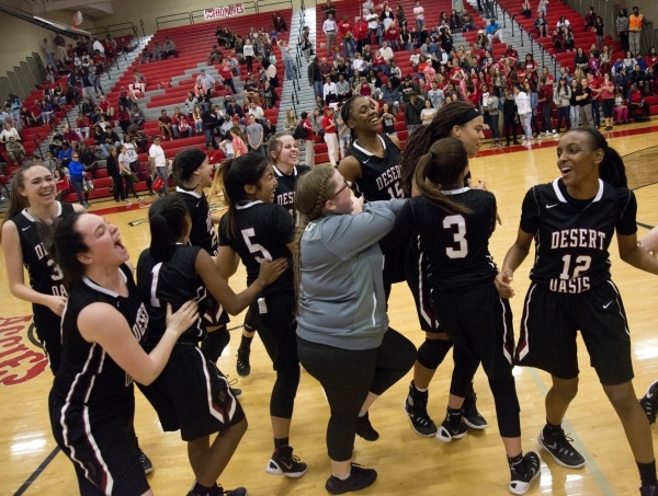 The Desert Oasis High School girl‘s basketball team celebrates after winning their gam ...