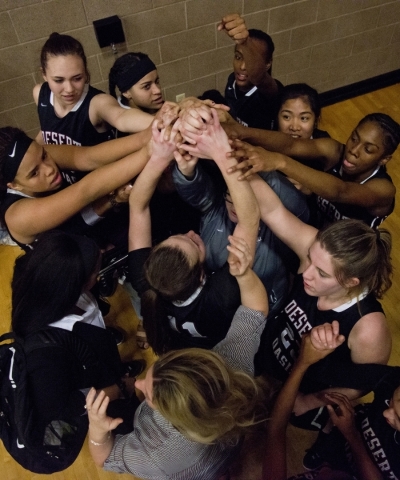 The Desert Oasis High School girls basketball team celebrates after winning their game again ...