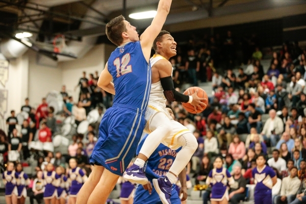 Durango junior Demetrius Valdez (13) leaps for the basket as Bishop Gorman senior Zach Colli ...