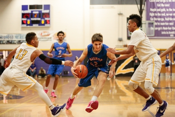 Bishop Gorman senior Byron Frohnen (3), drives between Durango junior Demetrius Valdez (13) ...