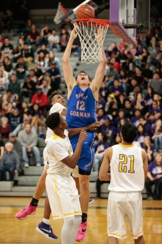 Bishop Gorman senior Zach Collins (12) center shoots a basket while surrounded by Durango de ...