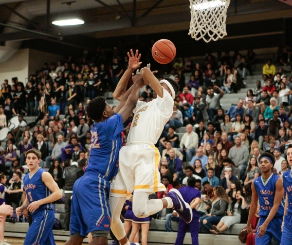 Bishop Gorman junior Christian Popoola (22) shoots a basket while Durango senior Michael Dig ...