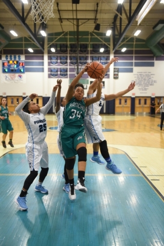Rancho‘s Courtney Plumer (34) grabs a rebound against Canyon Springs defenders D&lsquo ...