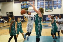 Canyon Springs D‘Licya Feaster (25) goes up for a shot against Rancho‘s Samantha ...