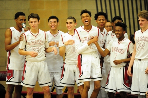 Desert Oasis players celebrate their 87-65 victory over Legacy during their prep basketball ...