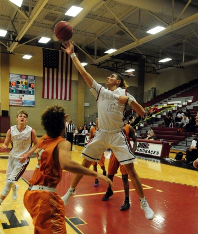 Desert Oasis guard Andrue Aguilera goes up for a shot against Legacy in the first quarter of ...
