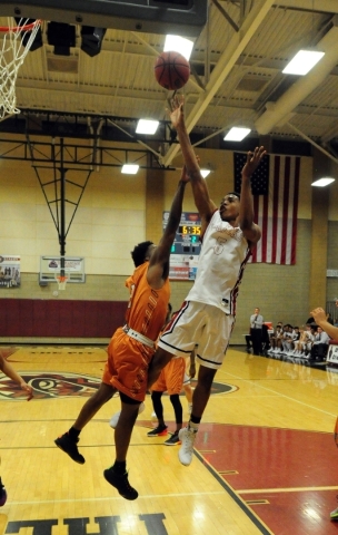 Desert Oasis forward Aamondae Coleman (5) goes up for a shot against Legacy guard Timothy Je ...