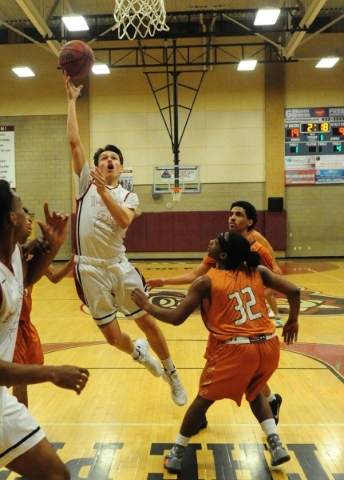 Desert Oasis forward Daron Fuglesten (23) goes up for a shot in front of Legacy guard Kamero ...
