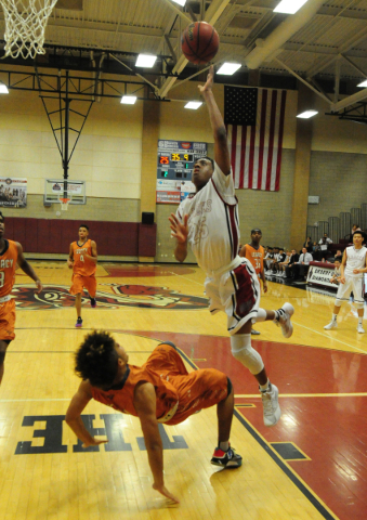 Desert Oasis guard Drevin Cannon (25) fouls Legacy forward Frank Robinson in the first quart ...