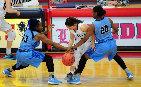 Foothill guard Amanda Carducci, center, loses control of the ball in front of Canyon Spring ...