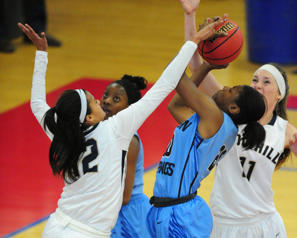 Foothill guard Rae Burrell (12) blocks the shot of Canyon Springs forward Alexia Thrower (20 ...