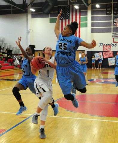 Foothill guard Amanda Carducci (1) goes up for a shot while Canyon Springs guard D‘Li ...