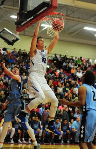 Bishop Gorman forward Zach Collins (12) dunks in front of Centennial forward Jake Hutchings ...