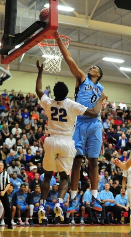 Centennial guard Troy Brown (0) blocks a shot attempt by Bishop Gorman guard Christian Popoo ...