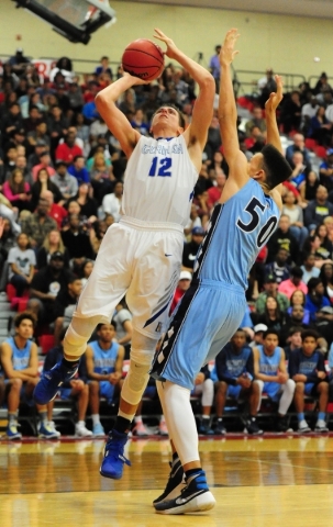 Centennial center Darian Scott (50) fouls Bishop Gorman forward Zach Collins (12) in the fir ...