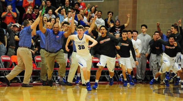 Bishop Gorman players and coaches celebrate their Sunset Region championship after defeating ...