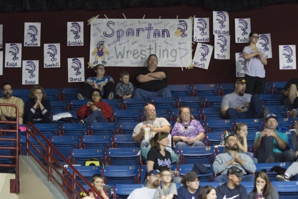 Spectators sit with their signs at the NIAA Nevada State High School Wrestling Championships ...