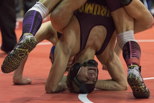 Gino Gusman, foreground, of Pahrump Valley High School wrestles Jimmy Brown of Boulder City ...