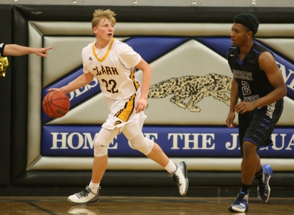 Clark High School sophomore Trey Woodbury (22) dribbles the ball downcourt past Desert Pines ...