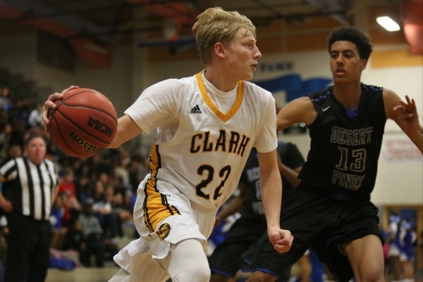 Clark High School sophomore Trey Woodbury (22) dribbles the ball around Desert Pines High Sc ...