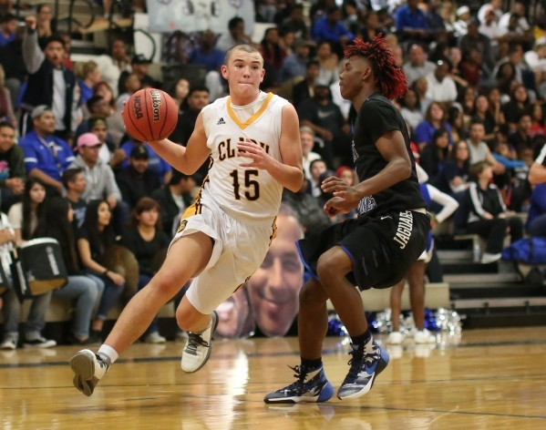 Clark High School sophomore James Bridges (15) dribbles the ball around Desert Pines High Sc ...