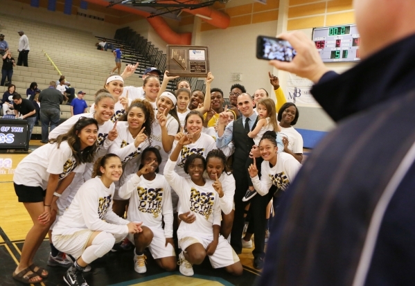 Spring Valley girls basketball team takes a personal photo after winning the NIAA Division 1 ...