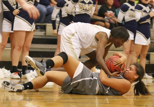 Faith LutheranÂ´s Kayla Proctor, bottom, and Spring Valley‘s Alana Walker struggle o ...