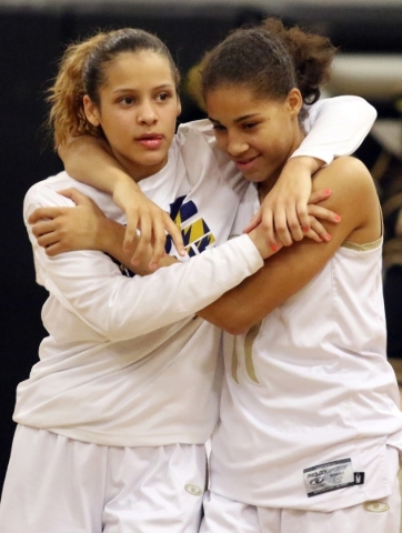 Spring ValleyÂ´s Essence Booker, left, and Kayla Harris embrace after their team won the ...
