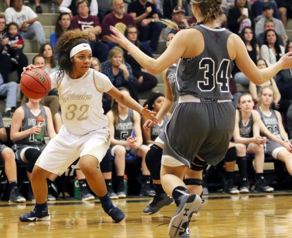 Spring ValleyÂ´s Lynnae Wilds, left, drives the ball near Faith Lutheran defenders during ...