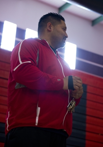 Liberty High School girls basketball coach Chad Kapanui stands on the court during practice ...
