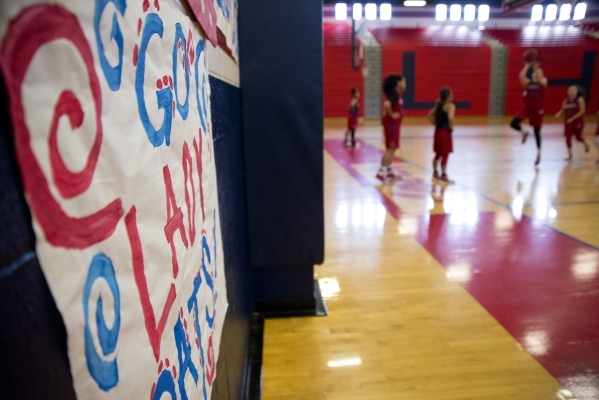 The gym is decorated with a sign to encourage the girls basketball team during practice at L ...