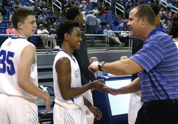 Bishop Gorman Head Coach Grant Rice celebrates with Chance Michaels, left, and DJ Howe after ...