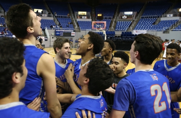 Bishop Gorman players celebrate after defeating Coronado 83-63 in the NIAA Division I state ...