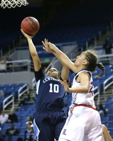 Centennial‘s Jayden Eggleston shoots over Liberty defender Kaily Kaimikaua during the ...