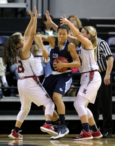 Centennial‘s Samantha Thomas is pressured by Liberty defenders Alexis Tomassi, left, a ...